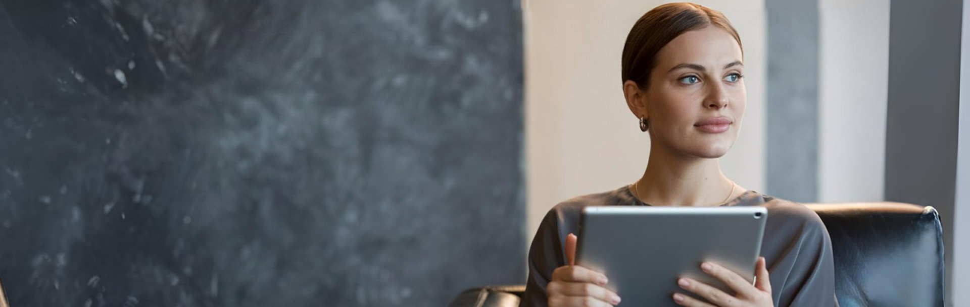 A woman reading on a tablet
